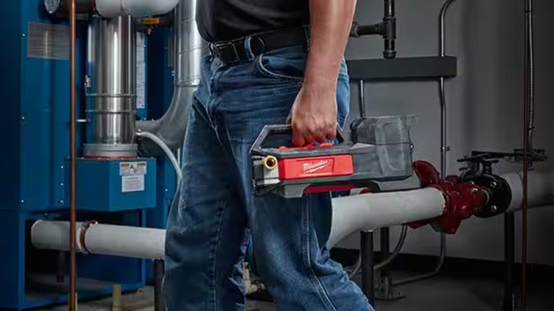 Worker holding a Milwaukee Transfer Pump